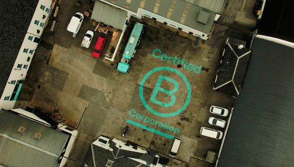 aerial view of bruichladdich distillery on Islay with b corp logo painted in yard