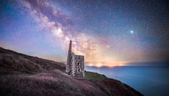 astrophotography of the milky way over a derelict wheal house on the coast of cornwall